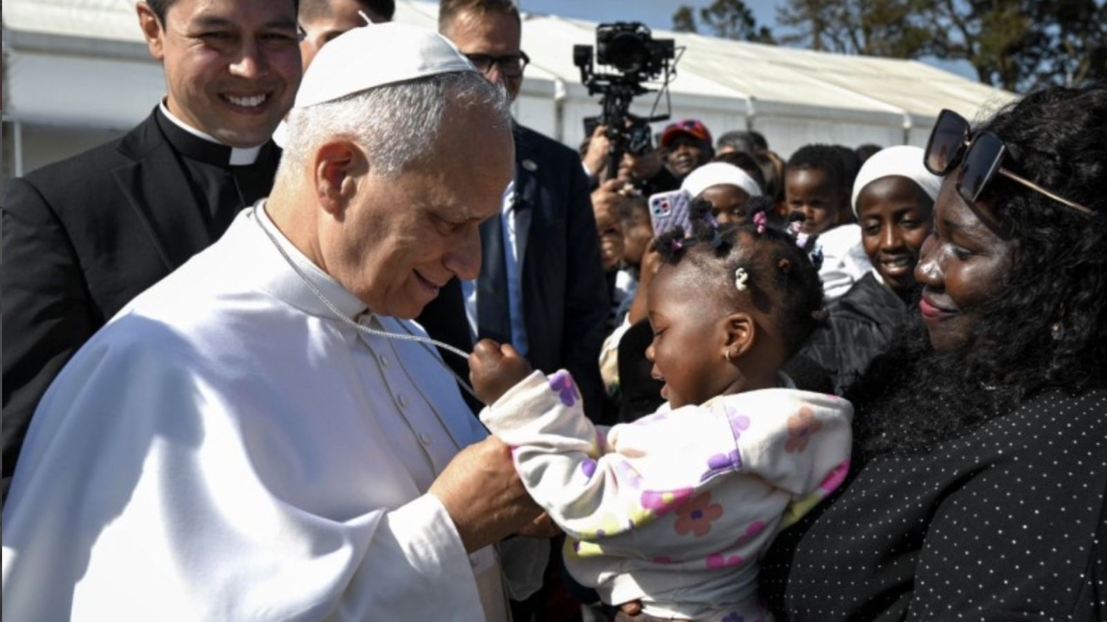 Papa con emigrantes