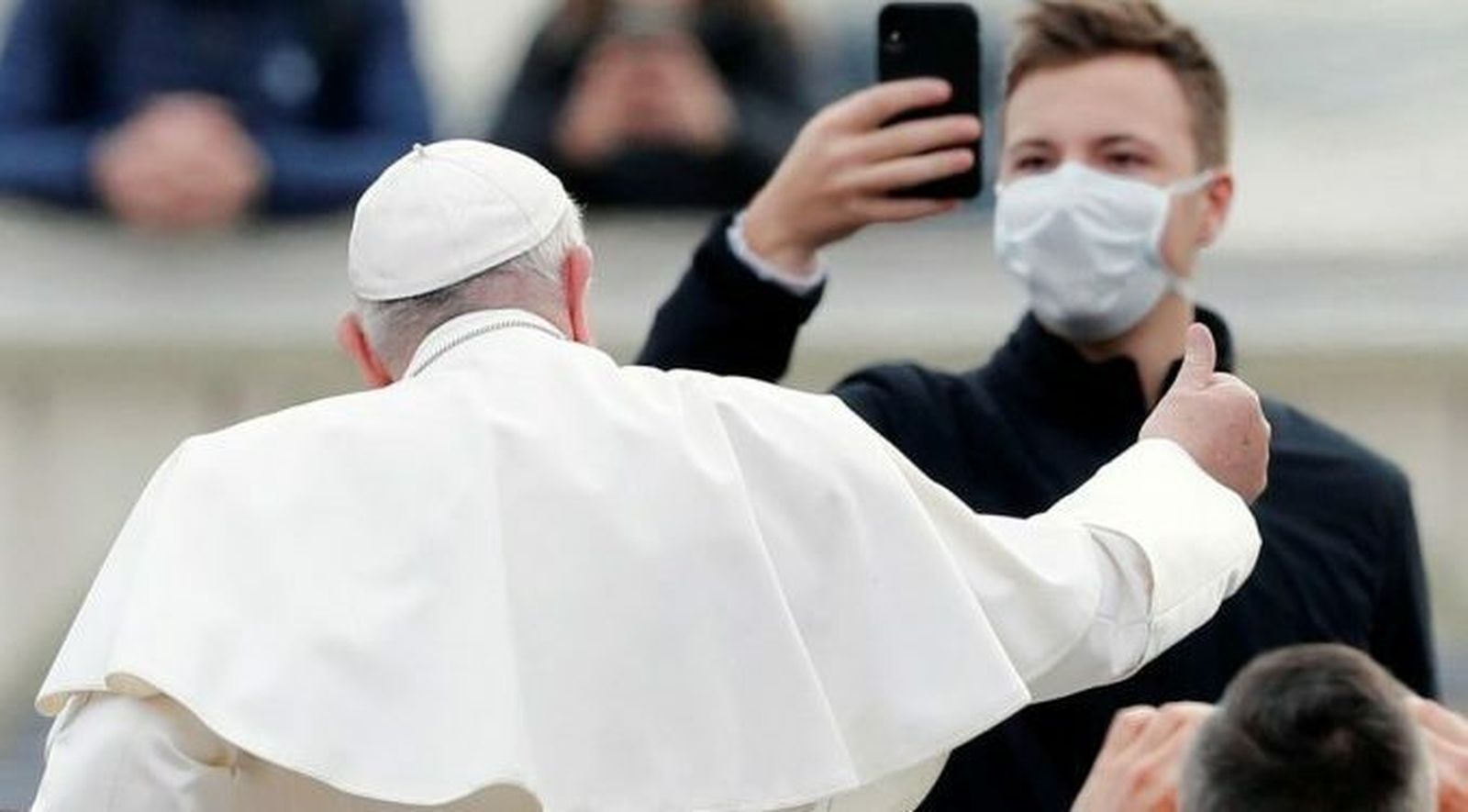 El Papa saluda a un fiel que le graba con una mascarilla puesta
