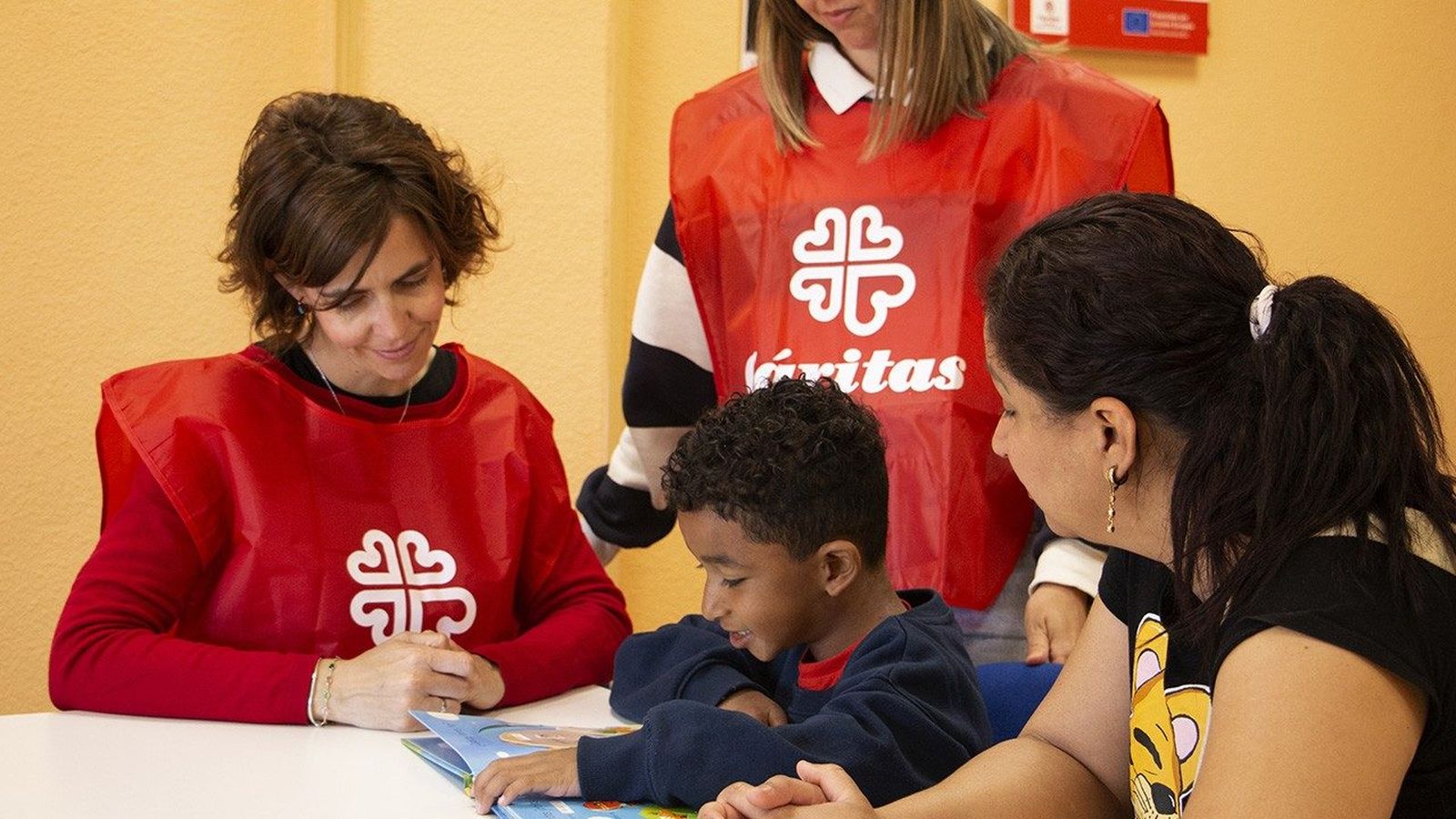 Voluntarios de Cáritas Española dan la bienvenida a un niño inmigrante
