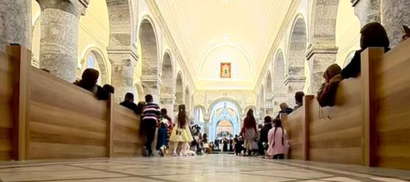 Los niños escuchan, sentados en el suelo, al Papa en Qaragosh