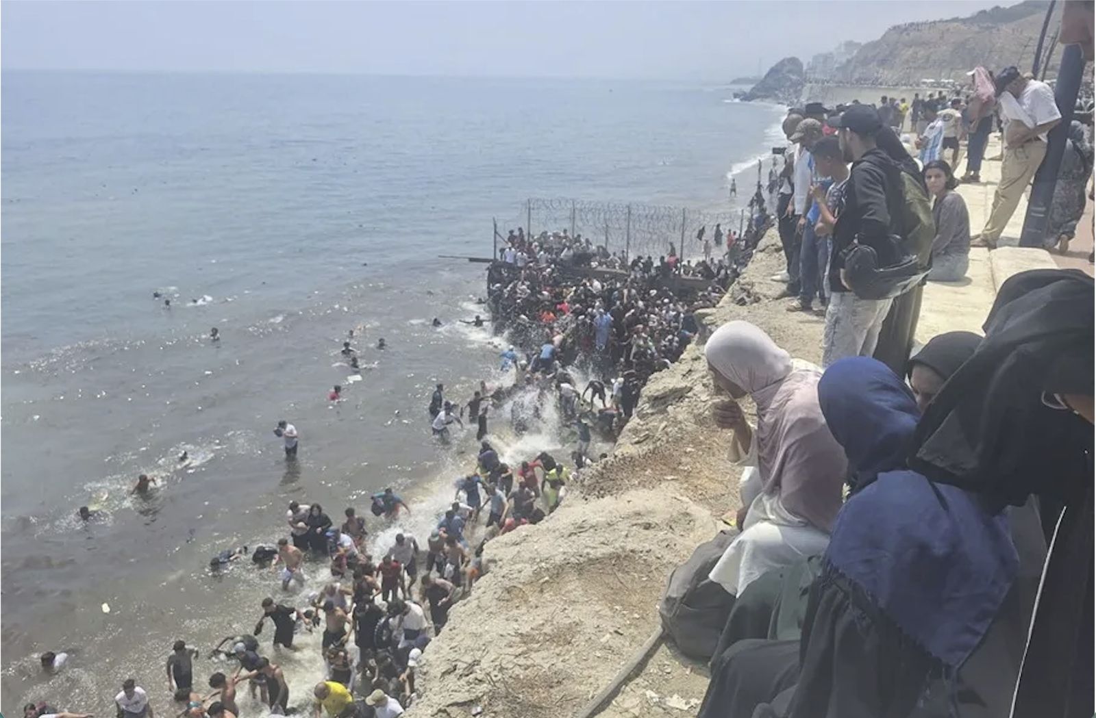 Jóvenes migrantes cruzando la frontera en Ceuta