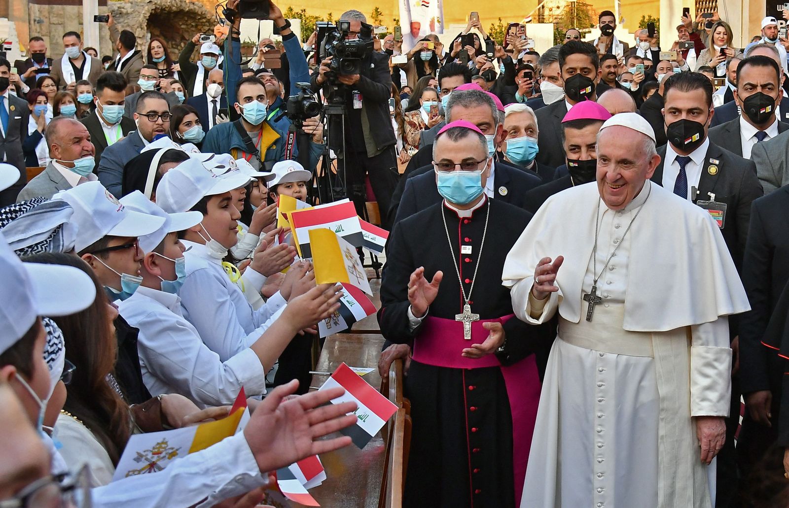 Francisco se encuentra con unos niños antes de entrar en la catedral de Bagdad