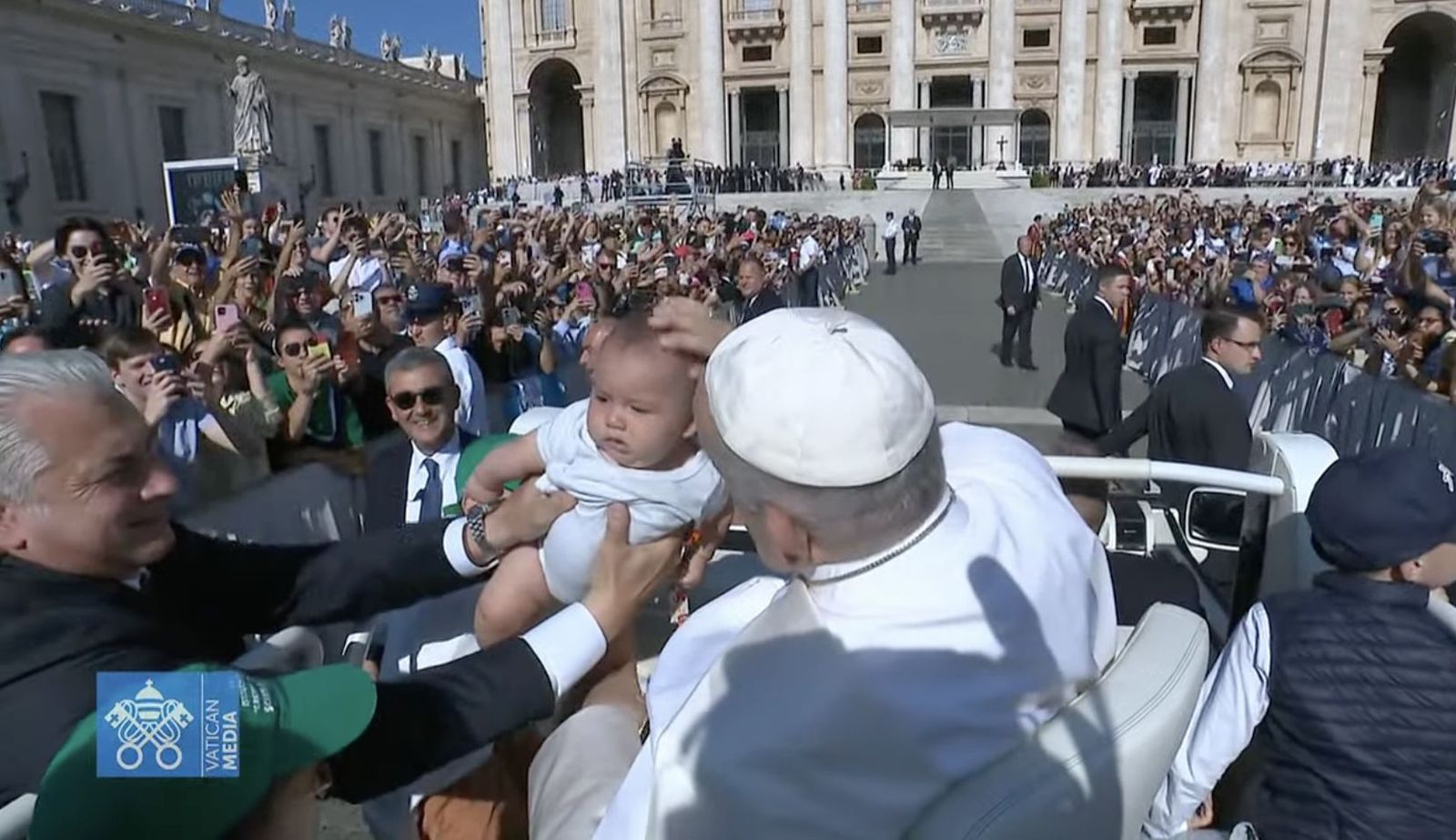 Francisco bendice a un bebé durante su recorrido por las de San Pedro