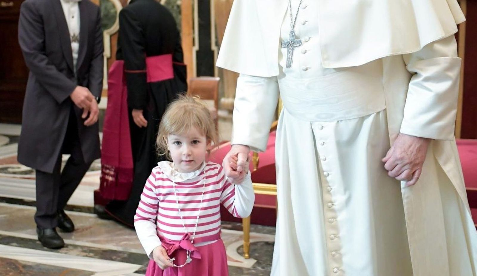El Papa de la mano con una niña